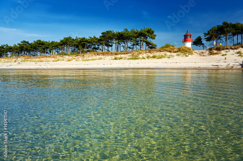 lighthouse Gellen on lonely summer beach photo
