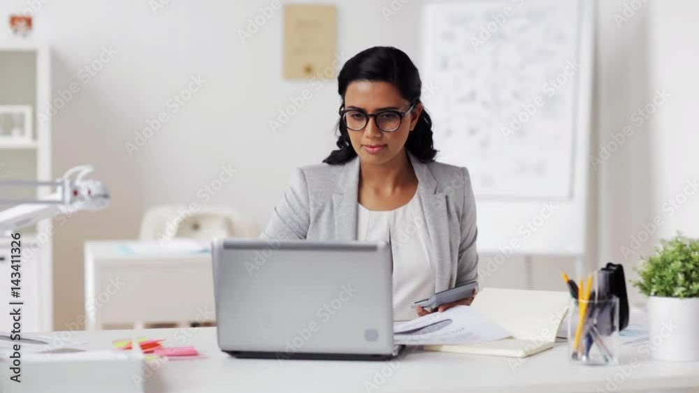 businesswoman with laptop and calculator at office businesswoman with laptop and calculator at office