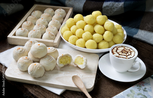 Dessert Chinese pastry or mooncake  for Chinese new year on wooden and book with coffee photo