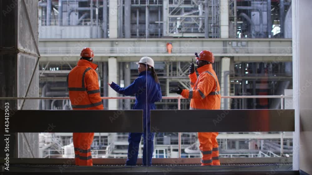Male & female engineers conducting checks at power station Male & female engineers conducting checks at power station
