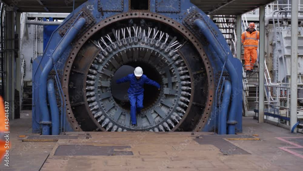 Female foreman in power station discussing operations with male colleague Female foreman in power station discussing operations with male colleague