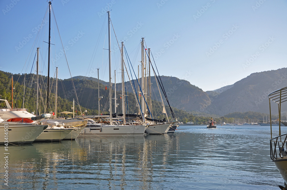 White yachts in the marina and mountains