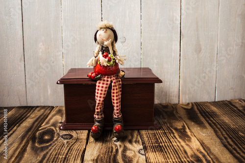 toy redhood sitting on wooden box photo