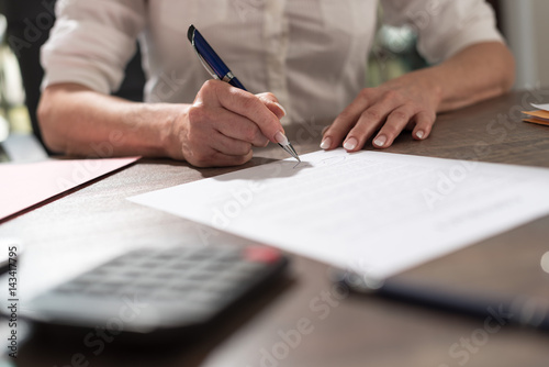 Businesswoman signing a document