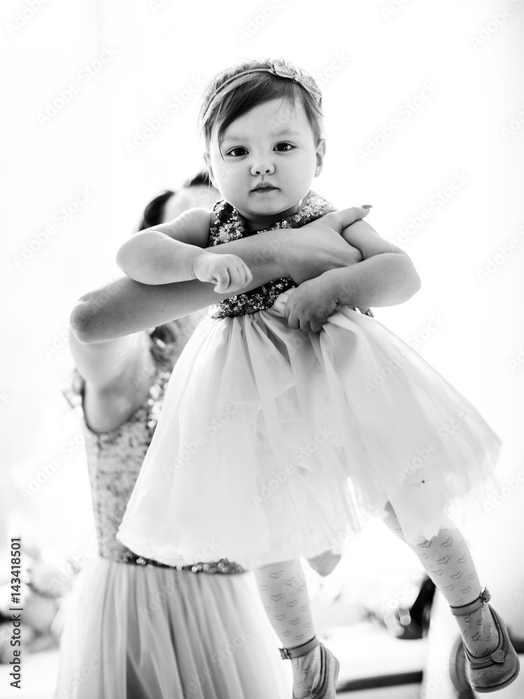 Black and white picture of little girl in mother's arms Black and white picture of little girl in mother's arms