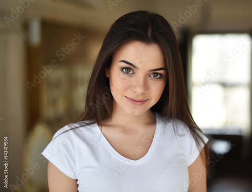 portrait of a brown-eyed brunette by the window