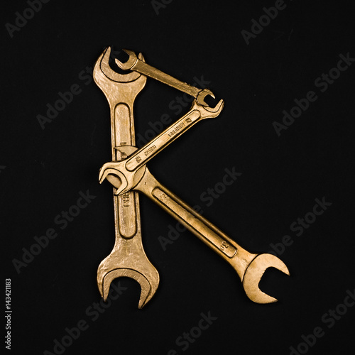 Letter R. Alphabet made of golden repair tools