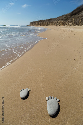 Footprint made of pebbles on the beach