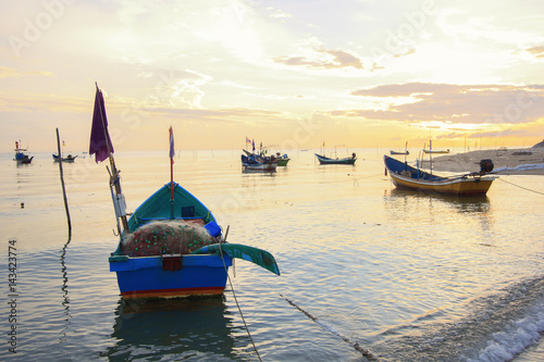 Group of small fishing boats at coast in morning ; Songkhla province, Thailand (selective focus) 