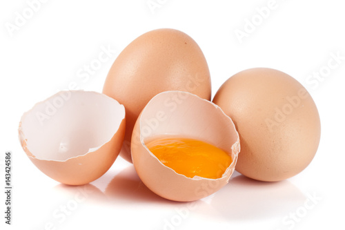 two whole eggs and broken egg isolated on white background