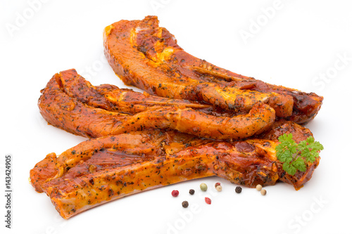 Spicy marinated spare ribs barbecued on the white background.