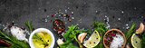 Selection of spices herbs and greens. Top view black background. Long banner format