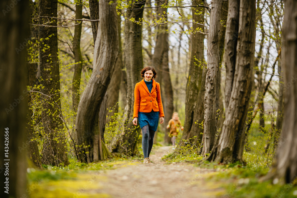 The beautiful girl walking along park The beautiful girl walking along park