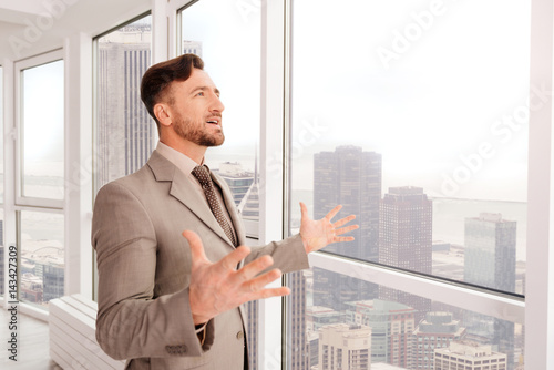 Successful businessman enjoying the view from his office