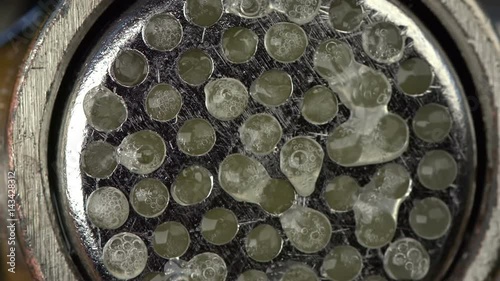 Macro shot of squeezing garlic out of garlic press photo