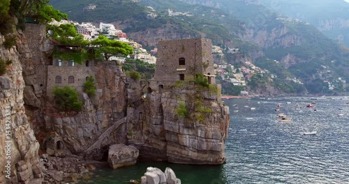 Discovering Positano village aerial shot with boats in sea