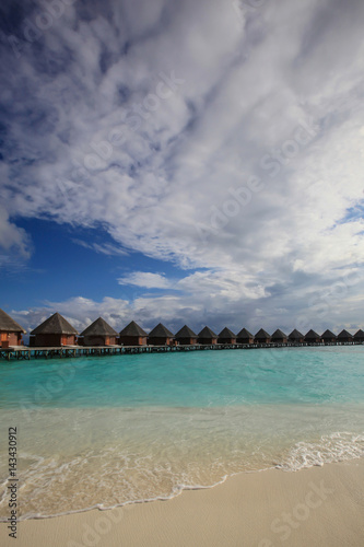Fototapeta Naklejka Na Ścianę i Meble -  Traditional Maldives bungalows on wooden pier in tropical paradise