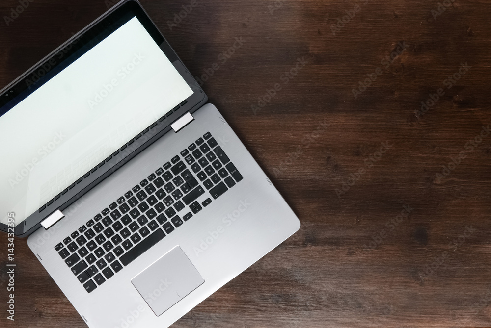 Top view of isolated laptop on desk, dark brown wooden workspace Top view of isolated laptop on desk, dark brown wooden workspace