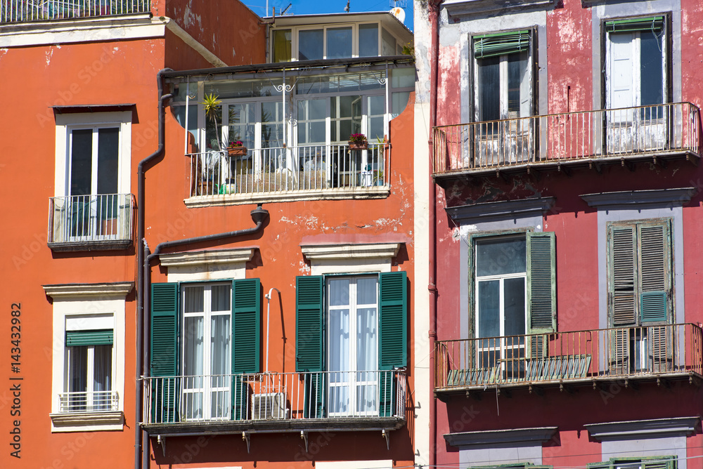 Traditional Italian red houses with green windows