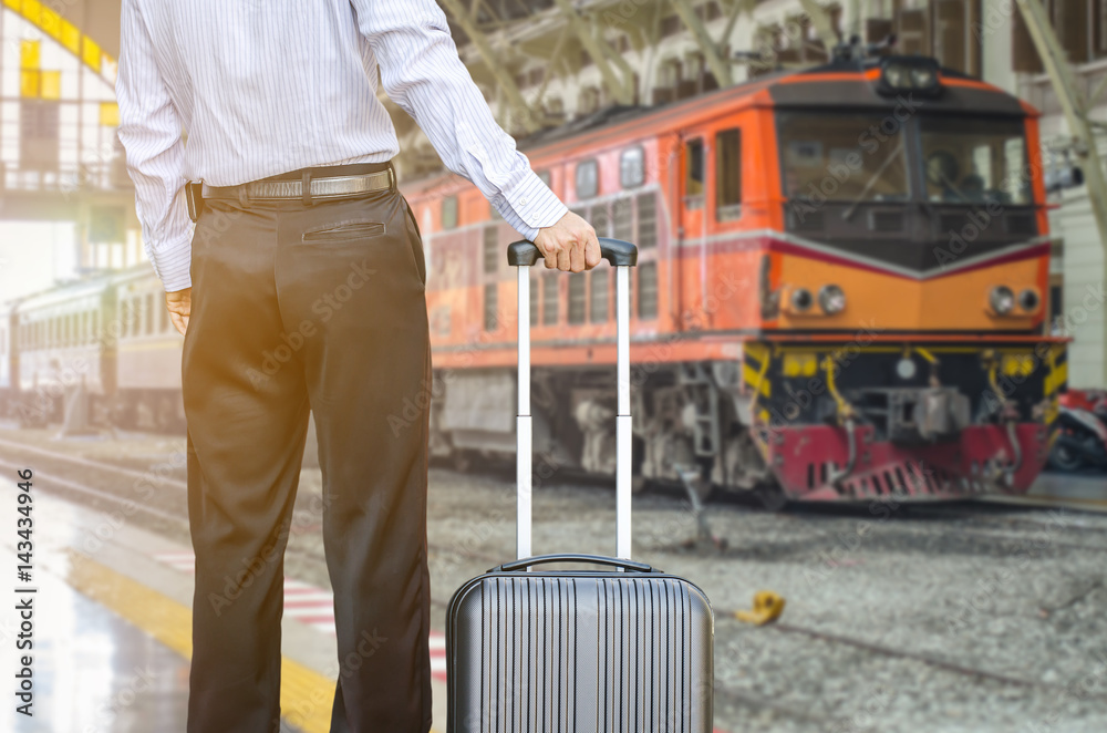 Businessman standing on the platform of a train station