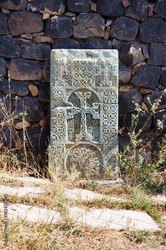 Close up of khachkar, covered with lichen, located on the bank of Sevan Lake, on cemetery of Hayravank Monastery, Armenia. photo