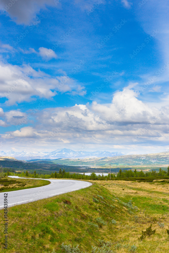 Road in Norway. Summer landscape with blue sky and mountains
