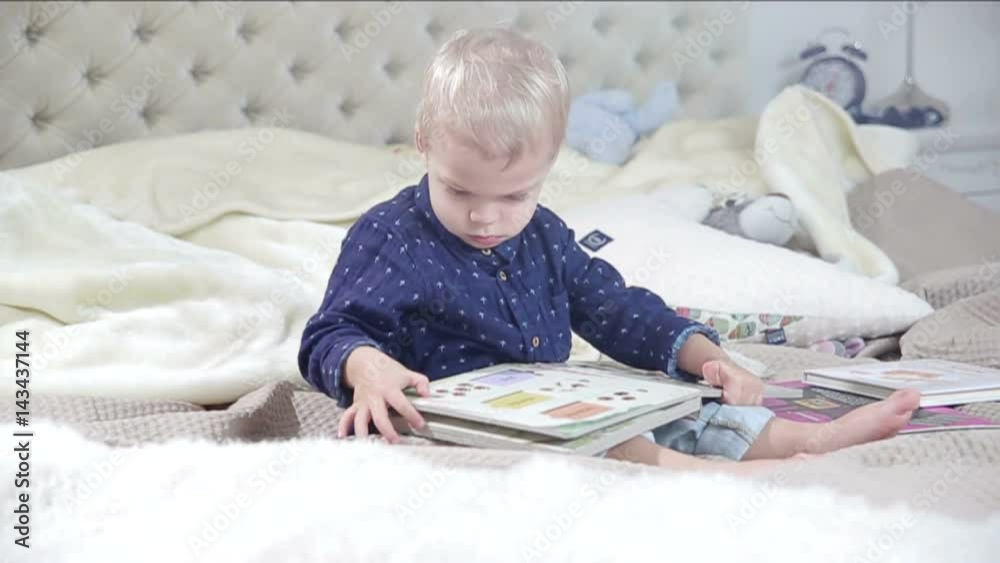 Little boy is browsing a book. FULL HD. Little boy is browsing a book. FULL HD.