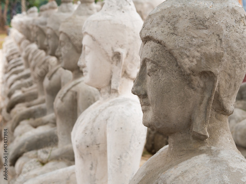 row of Buddha statue Made of cement, in Thailand.