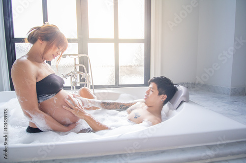 Pregnant woman with her husband spend much time together