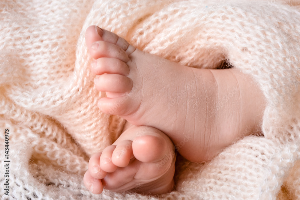 Small newborn legs. Happiness of parents. Small newborn legs. Happiness of parents.
