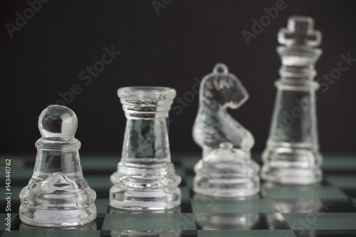 Glass chess team: king, pawn, knight and rook