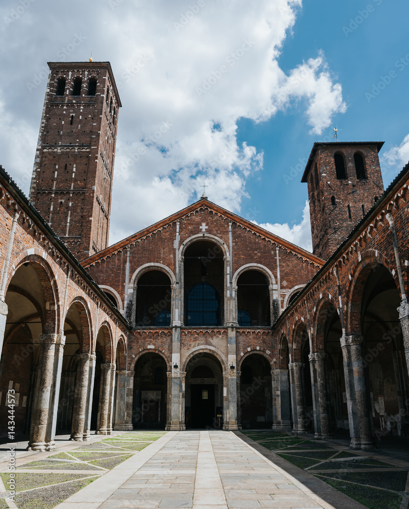 Towers in courtyard of Saint Ambrogio basilica, Milan, Italy. Summer travel postcard.