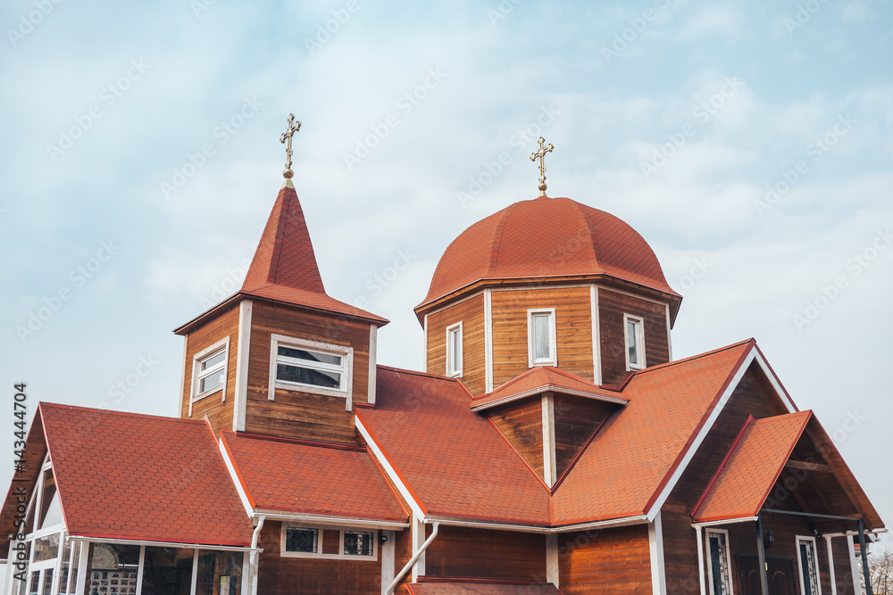 the roof dome and cross of an old wooden Church.