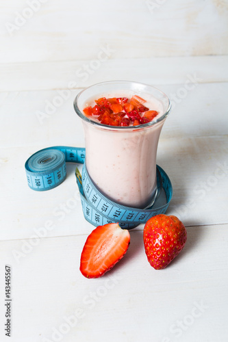 Strawberry yogurt smoothie with measure tape