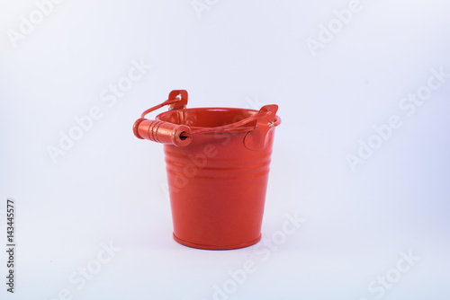 Single red bucket isolated on a white background © Nestyda