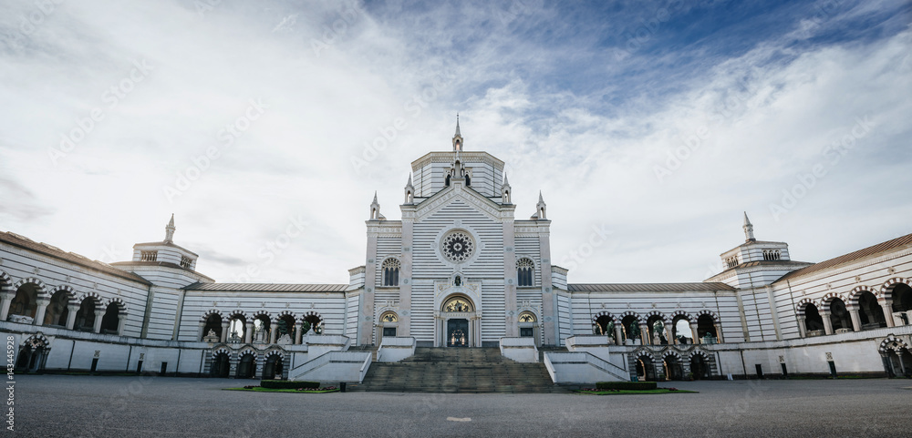 Famedio chapel facade at the Monumental Cemetery (Cimitero Monumentale), one of the main landmarks and tourist attractions af Milan, Italy. Scenic horizontal view panorama.