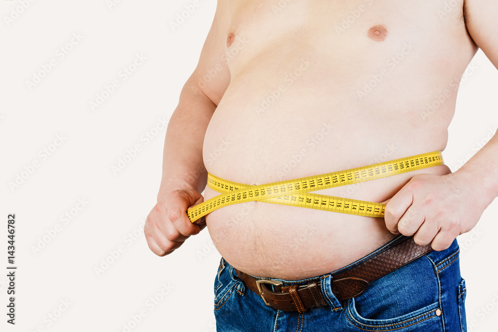 Man belly fat with tape measure weight loss around body on black