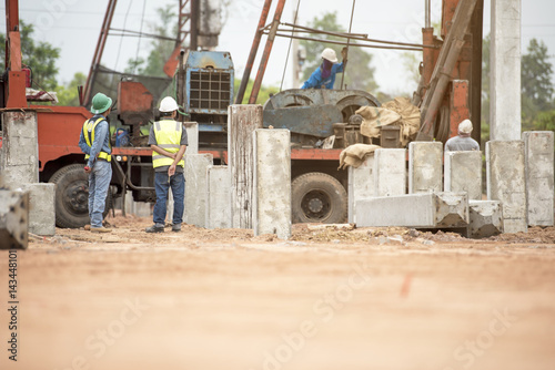 Two engineer inspec construction site pile driving photo