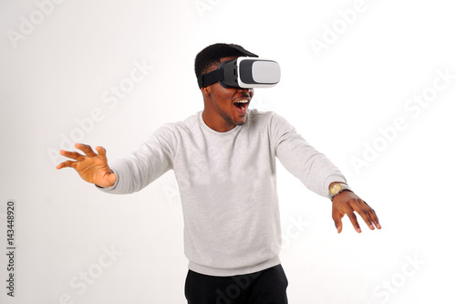 Black guy with virtual reality glasses isolated on white © lisovoy
