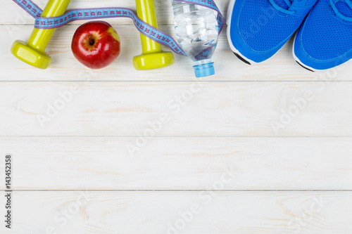 Fitness and dieting concept idea on white wood background.