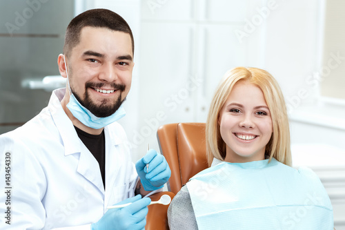 Dentist she trusts. Portrait of a professional dentist and his client smiling cheerfully to the camera