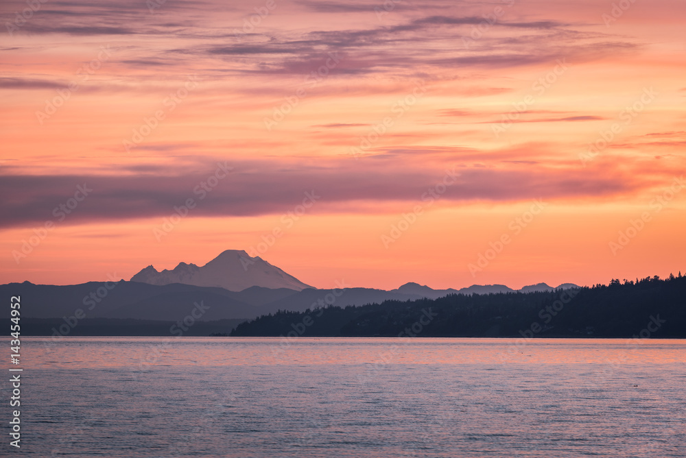 Dawn over Northwest Washington as a pink morning sky fills the frame above the volcanic Mount Baker and Puget Sound