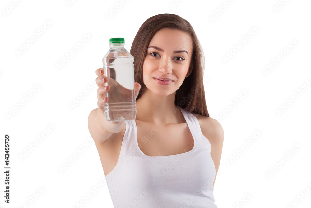 Beautiful healthy young girl drinking a bottle of pure clean water. Pretty woman holding a bottle of water in her hands on isolated background. Beautiful healthy young girl drinking a bottle of pure clean water. Pretty woman holding a bottle of water in her hands on isolated background.