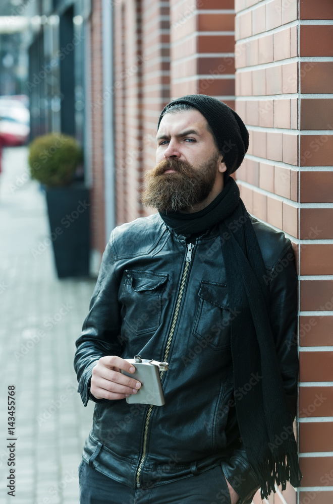 serious bearded man hipster with metallic jar in leather jacket serious bearded man hipster with metallic jar in leather jacket