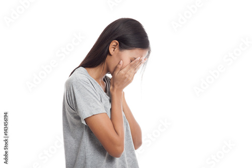 Sad young Asian woman cry with palm to face.