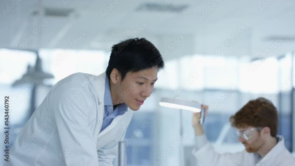 Electronics engineers working in the lab with manager overseeing Electronics engineers working in the lab with manager overseeing