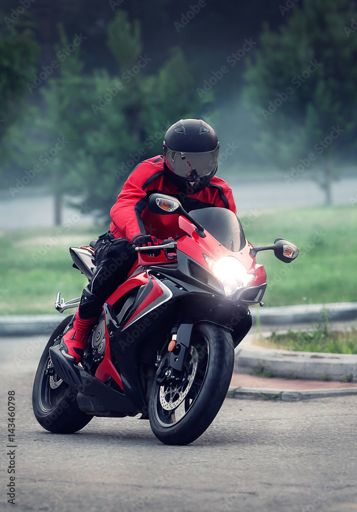 Biker in helmet ride on the red motorcycle