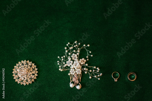 The bridal brooch,rings,hairpin and,earrings standing on the chair