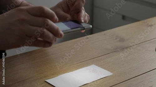 Using smartphone to mobile deposit check into bank account