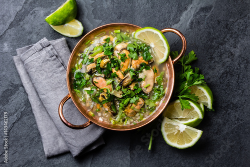 Seafood ceviche or mariscal in copper bowl - traditional Latin American dish with seafood, onion and lemon